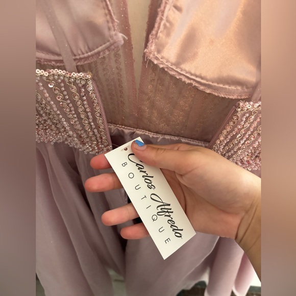 It’s a Mauve short Cinderella dress. Never been used, still has all its tags. - Picture 2 of 4